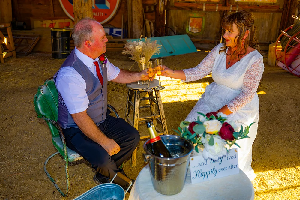 Wedding couple celebrating with a champagne toast at Nelson Ghost Town