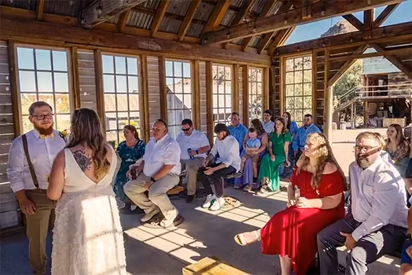 Guests gather for a full wedding celebration at Nelson Ghost Town, the historic canyon walls of Eldorado Canyon providing a dramatic backdrop