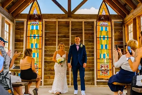 A small gathering of guests witnesses an intimate wedding ceremony in progress at Nelson Ghost Town in the Nevada desert